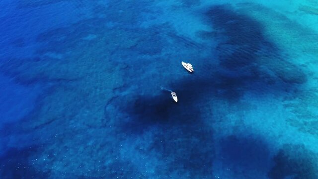 Aerial, zoom in, motor boats anchored off the coast of Oahu, Hawaii, USA