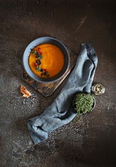  Spicy pumpkin soup with pumpkin seeds and pomegranate garnish. Flat layot, copy space.