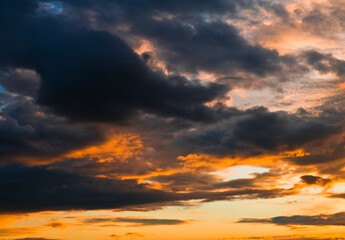 Beautiful sunset. Black and yellow clouds in the sky