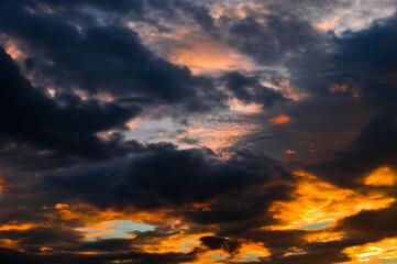 Beautiful sunset. Orange and black clouds in the sky