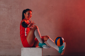 Young woman smiling volleyball player with ball