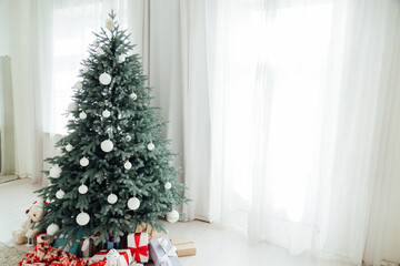 Christmas tree Christmas decoration interior of the white room with postcard gifts