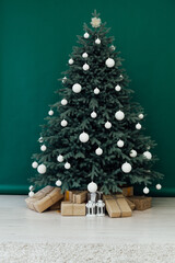 Christmas tree pine Christmas decoration interior of the green room with holiday postcard gifts