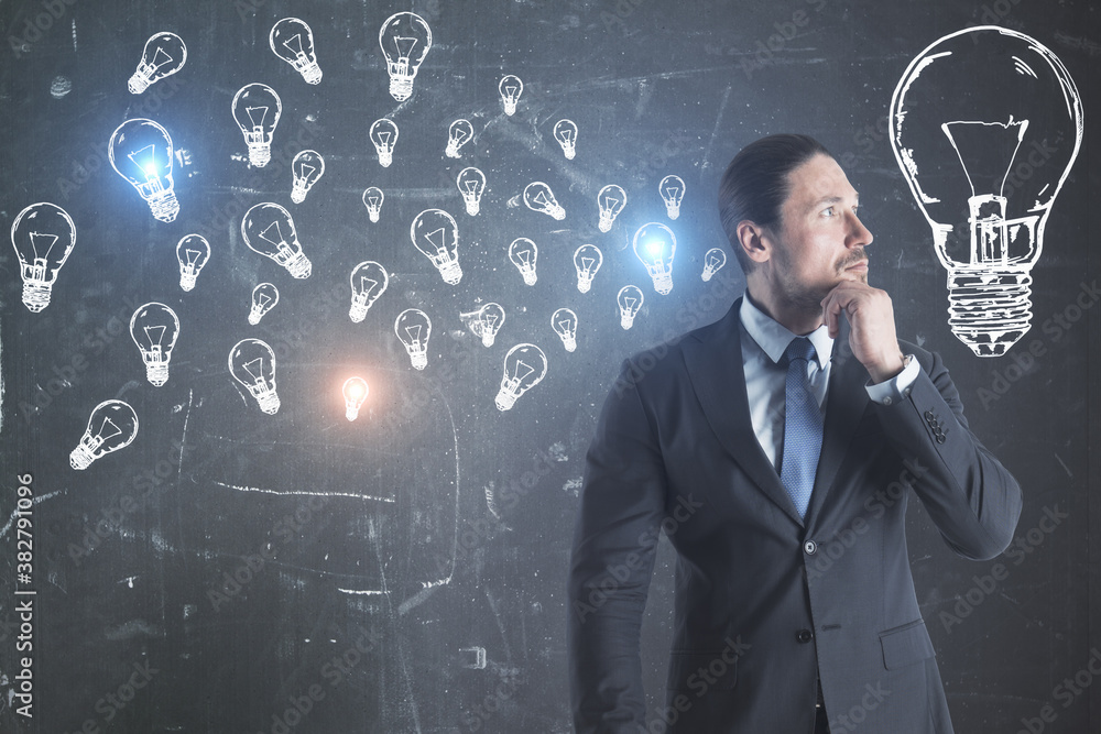 Poster young european businessman with creative lamps sketch on blackboard.