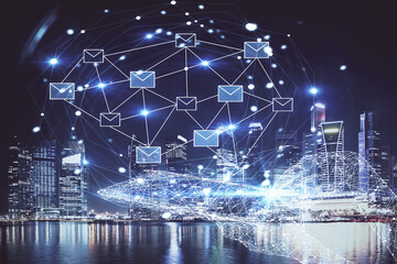Double exposure of envelop hologram flying from gadget and city view background. Concept e-mail.