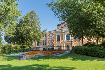 The Bayreuth Festspielhaus peeking through the trees, in front of the theatre