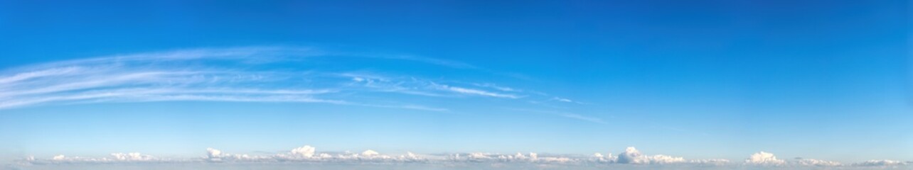 Fantastic clouds against blue sky, panorama