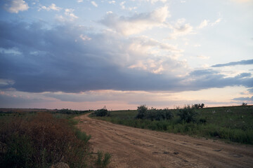 landscape ground road in countryside late summer evening with cloud sky