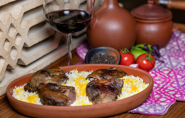 Grilled coot on the rice with red wine glass