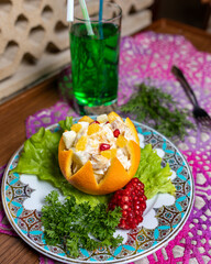 Fototapeta na wymiar Orange snack with pomegranate close up
