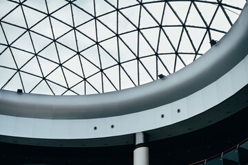 Fragment of glass dome made of metal triangular structures. Inside view from bottom