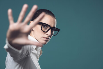 Confident woman making a stop gesture