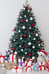 Christmas tree blue pine with gifts interior decor white room new year winter holiday
