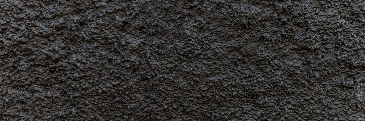 Black panoramic background. Grain black painted wall texture background