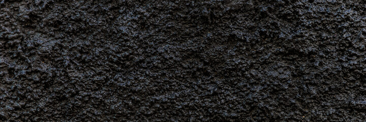 Fototapeta premium Black panoramic background. Grain black painted wall texture background