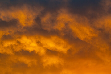 a close up of gold clouds on the horizon during a sunset over the Mediterranean