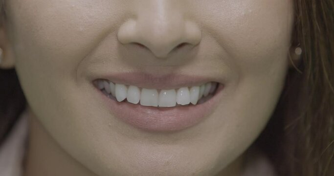 Slow motion, close-up, smiling mouth of an adult woman, London, UK