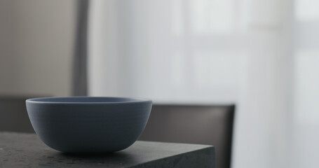 Empty blue bowl on concrete countertop with copy space