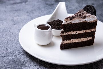 Delicious cookies and cream cakes on a white plate with round cookie powder and milk.