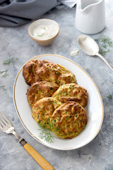 zucchini, courgette fritters or pancakes with herbs and sauce. Vegetarian healthy food.