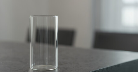 Empty highball glass on concrete countertop on kitchen