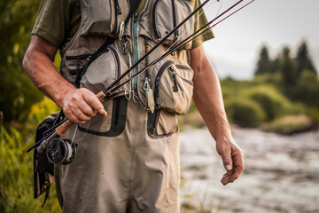 The fisherman is ready to go fishing. He's going to catch trout.