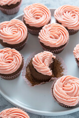 delicious chocolate cupcakes with strawberry buttercream, selective focus. Copy space.