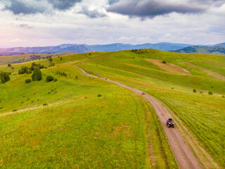 Obraz premium ATV rider rides through forest off-road in summer