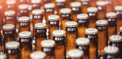 Beer bottles on conveyor production line belt. Brewery factory manufacturing plant