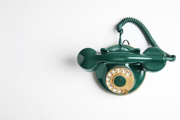 Elegant vintage green telephone isolated on white, top view