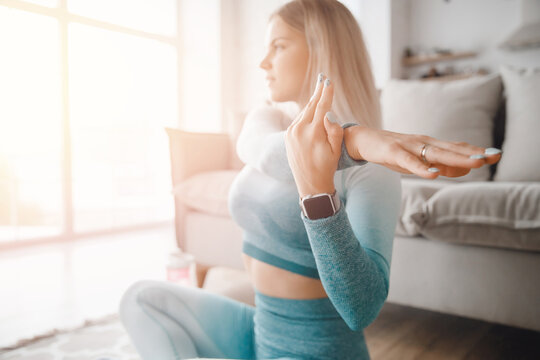 Blood Oxygen Measurement And Smartwatch Timer While Exercising Sport At Home. Young Slim Girl In Sportwear Doing Yoga