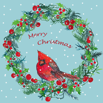 Red cardinal on a Christmas wreath painted with watercolors with snow in the blue sky background