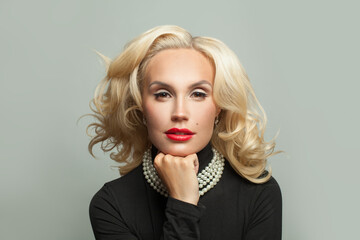 Elegant mature woman with blonde curly hairstyle and makeup
