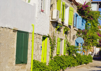 Fototapeta na wymiar colorful and stone houses in narrow street in Alacati cesme, izmir 