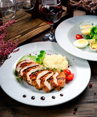 two course lunch grilled meat and fresh vegetable salad on the table