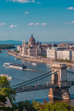 The panorama view of the skyline in Budapest, Hungary, with Sz&eacute;chenyi L&aacute;nch&iacute;d over the Danube, and  the parliament building in Hungary.