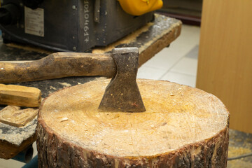 the axe is stuck in the stump. cutting wood. men's work. High quality photo