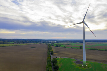 Wind turbine on a wind farm under windy and cloudy weather conditions