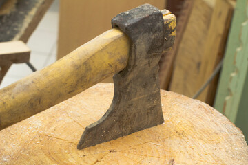 the axe is stuck in the stump. cutting wood. men's work. High quality photo