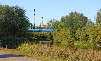 View from the Tsna embankment in Tambov to the pedestrian bridge and the bell tower