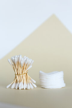 Cotton swabs with wooden sticks, fasial pads in background with copy space.