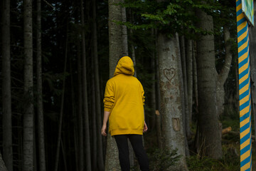 Girl in a dense coniferous forest