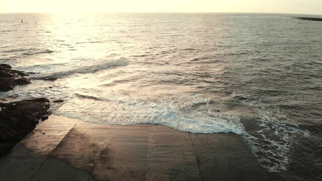 gorai beach dock waves on sun set dron shot