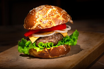 Fresh delicious burger on a wooden background 