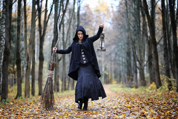 A woman in a witch suit in a forest