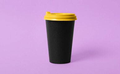 Takeaway paper coffee cup on violet background