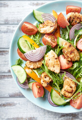 Healthy Salad with Chicken Breast, Cherry Tomatoes, Cucumber, Orange Pepper, Endive and Red Onion. Top view. Close up. 