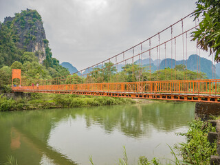Suspension bridge cross Nam Song River  at Tham Chang cave Vangvieng City Laos.Vangvieng City The...
