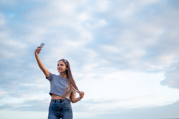 Obraz na płótnie Canvas Woman selfie portrait with blue sky