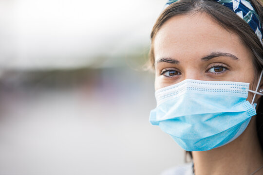 Close-up photo of a young woman wearing a protective mask against virus epidemic